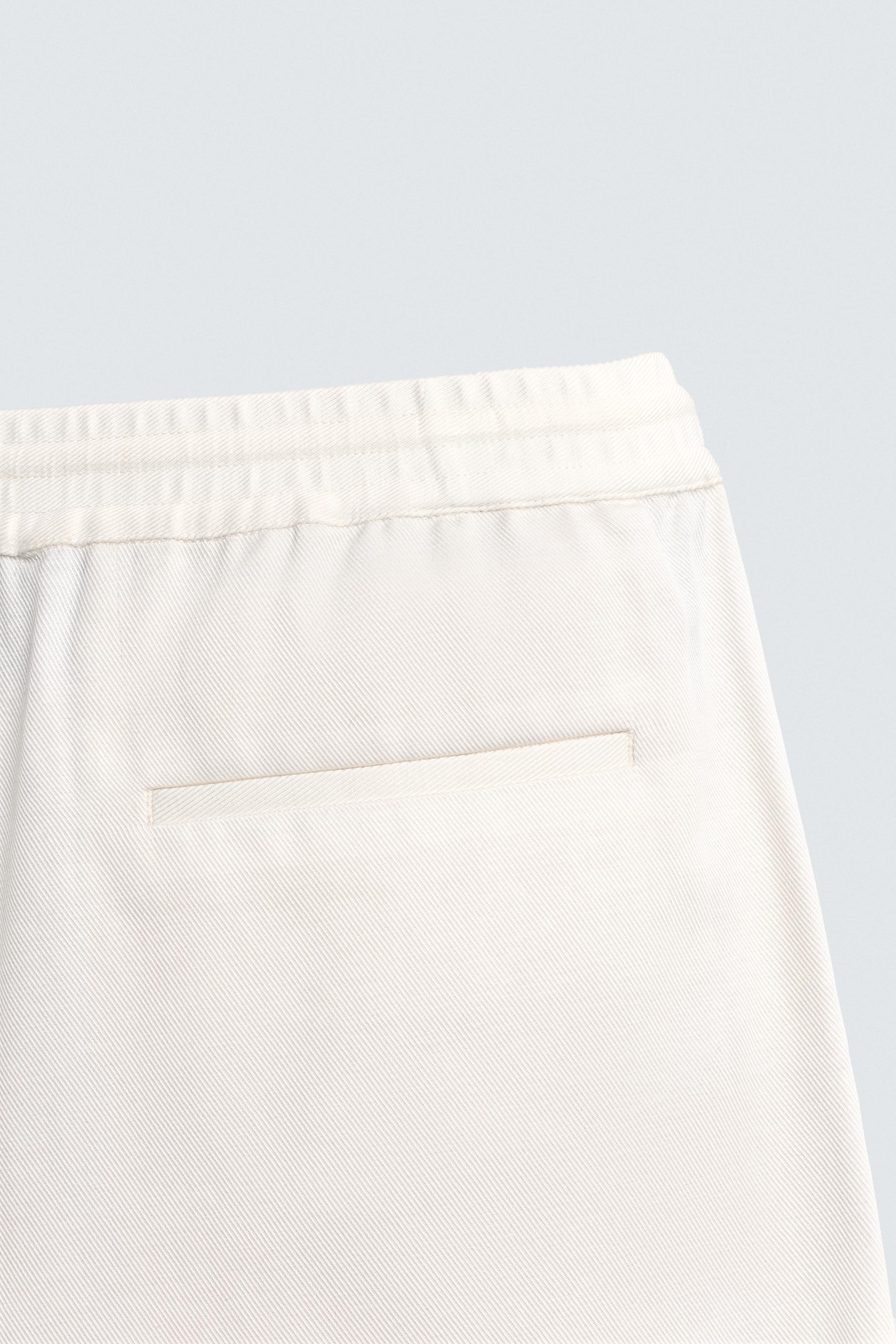 TEXTURED PLEATED PANTS